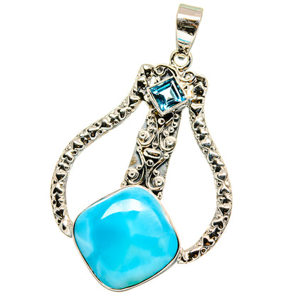 Sterling silver teardrop pendant with bright blue stone and decorative border.