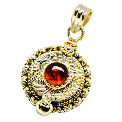 Sterling silver poison pendant with round red garnet-style stone and ornate bezel