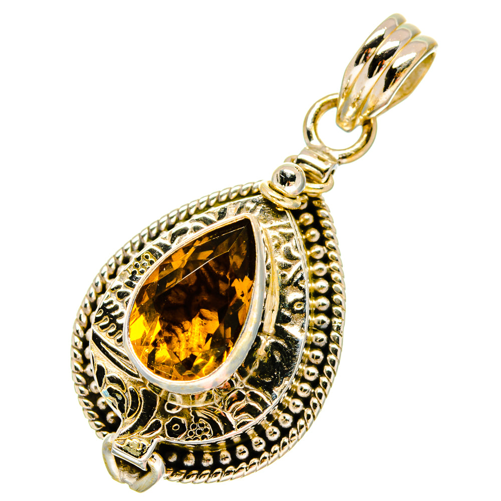 Teardrop citrine pendant with ornate silver filigree and hanging bail loop