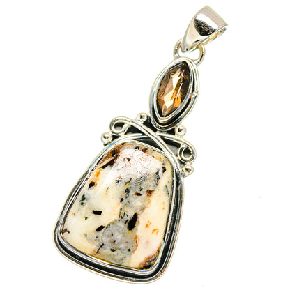 Sterling silver bail pendant with dark oval gemstone and pale speckled stone cabochon