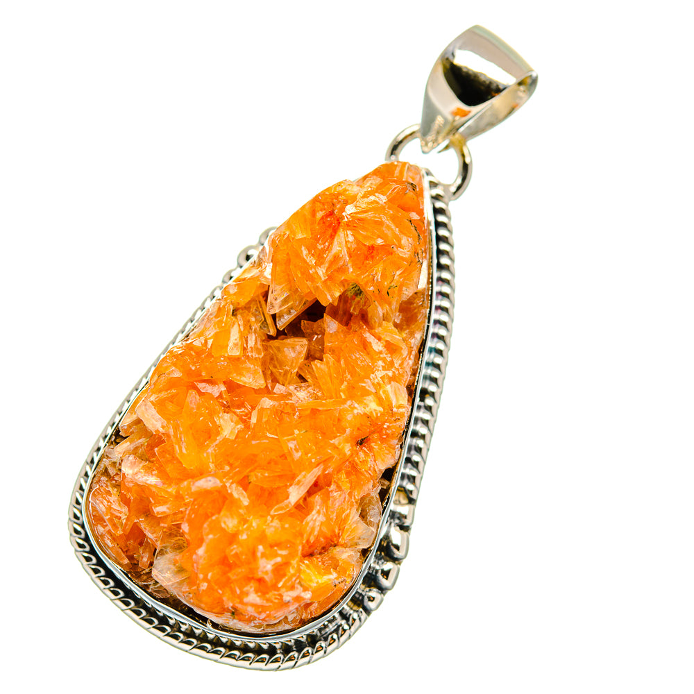 Orange crystal teardrop pendant with ornate silver bezel and loop bail