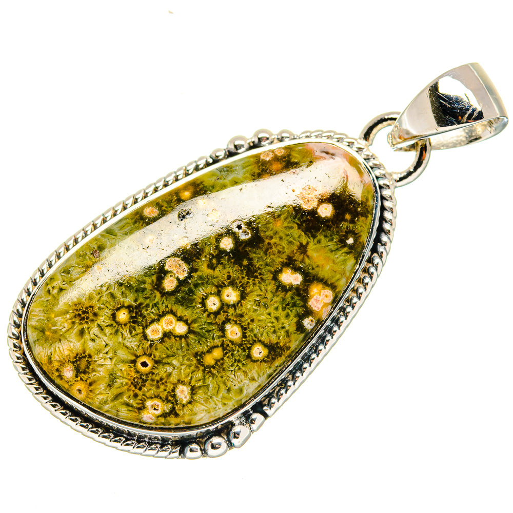 Ocean jasper teardrop pendant with silver bail, white and yellow dots on green stone.