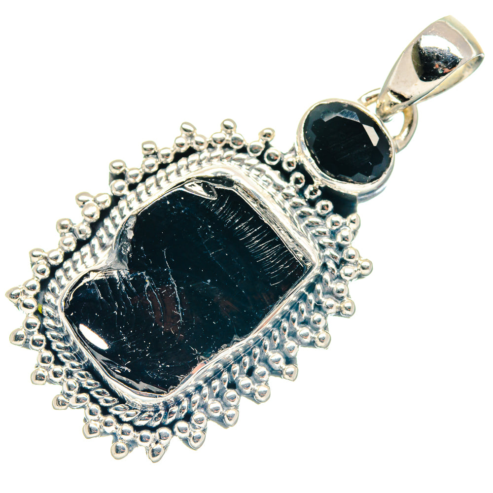 Rough black stone pendant with textured silver bezel and teardrop bail, sterling silver tone