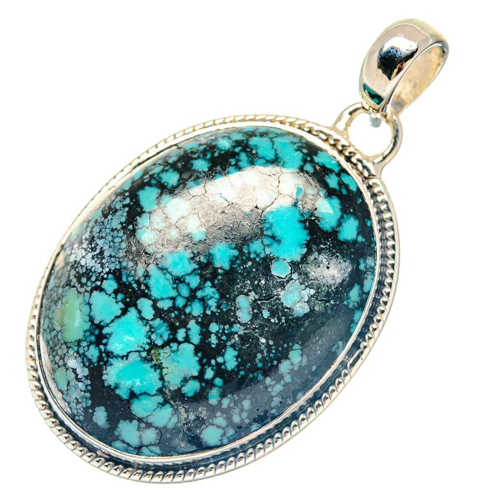 Oval turquoise pendant with black matrix stone in silver bezel, round bail loop