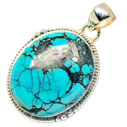 Oval turquoise cabochon pendant in sterling silver setting with bail, textured border