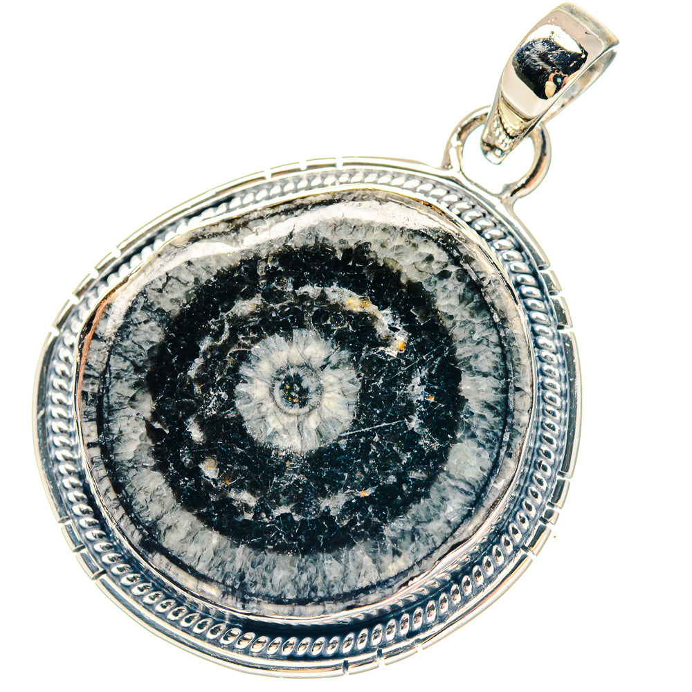 Round sterling silver pendant with detailed Evil Eye design and ornate border bezel