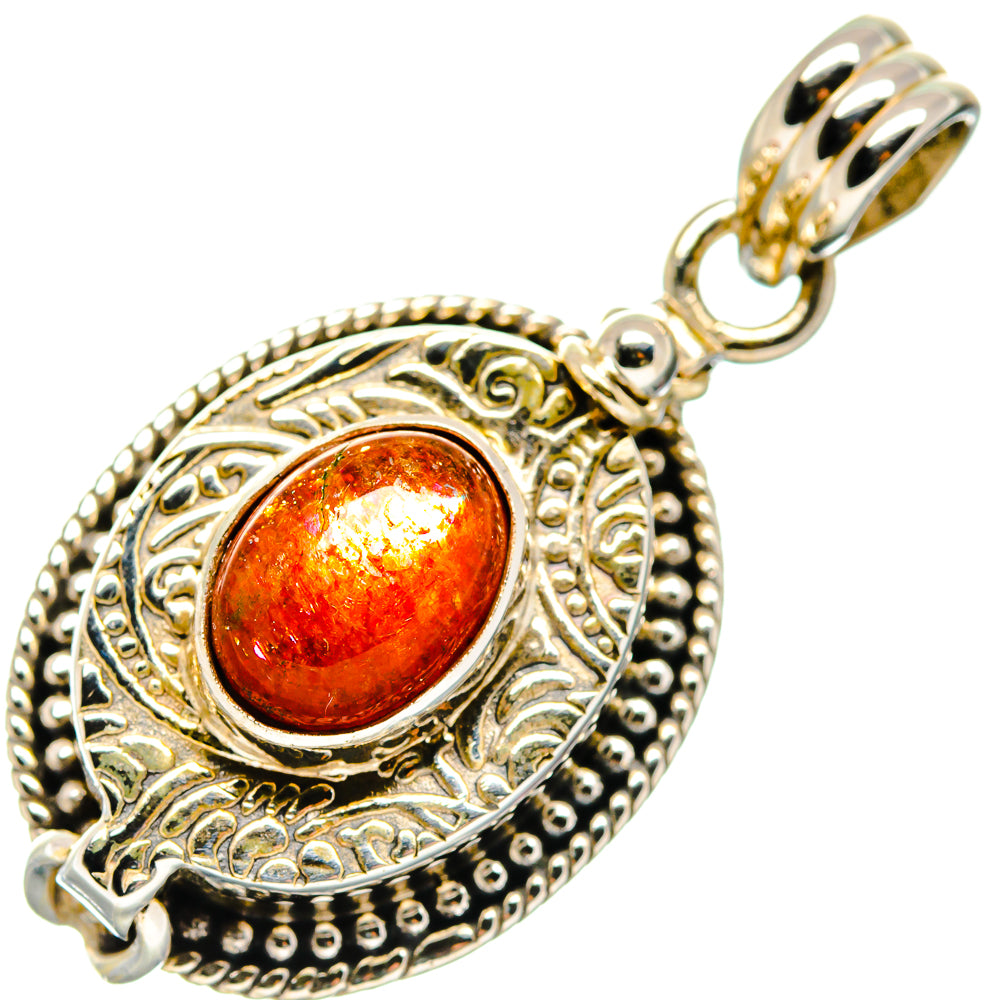 Sterling silver sunstone pendant with oval orange-red stone, filigree frame and bail