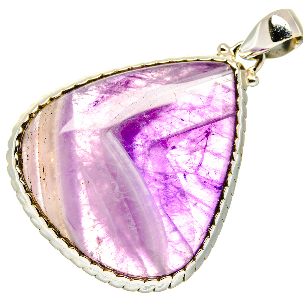 Amethyst teardrop pendant with purple cabochon and ornate silver bezel, top bail.