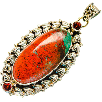 Oval garnet pendant in sterling silver with red-orange stone and filigree border