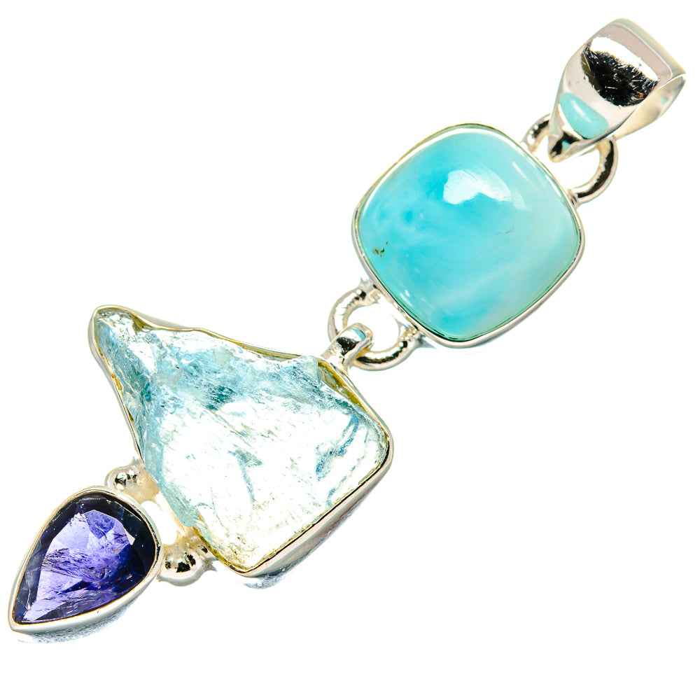 Silver pendant with oval aqua cabochon, rough pale stone, and purple teardrop accent