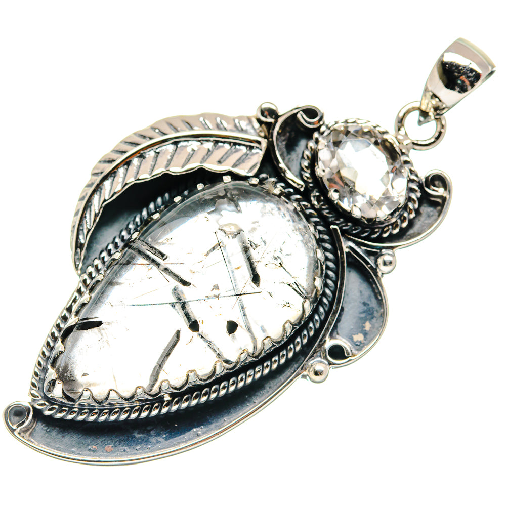 Silver-tone pendant with clear oval quartz and dark blue bezel detail
