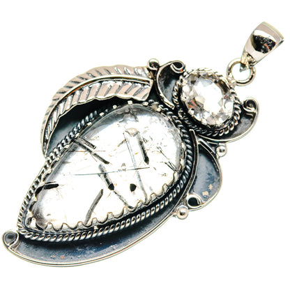 Silver-tone pendant with clear oval quartz and dark blue bezel detail