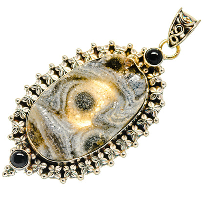 Oval druzy pendant with gray-gold texture, black onyx details, and ornate floral frame