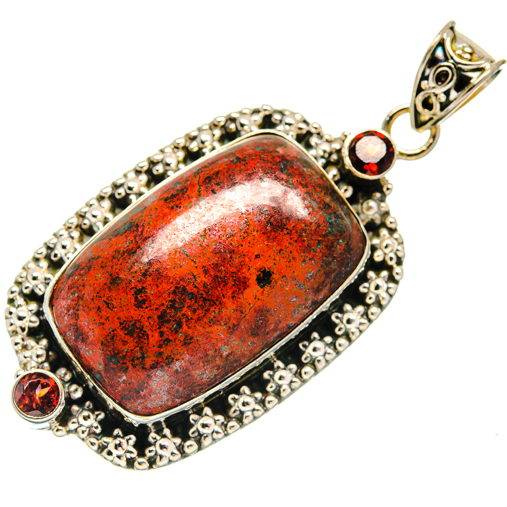 Oval Sonora Sunrise garnet pendant in silver with textured border and round red stones