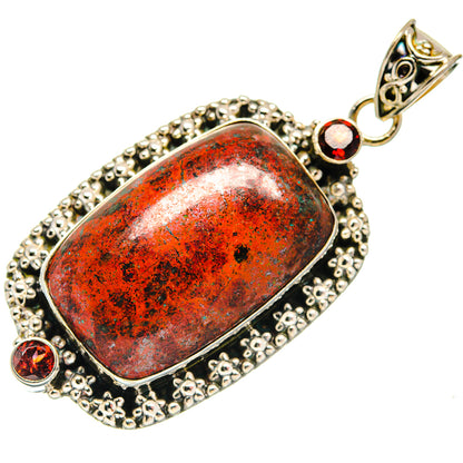 Oval Sonora Sunrise garnet pendant in silver with textured border and round red stones