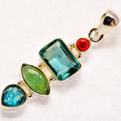 Sterling silver pendant with faceted teal stone, green and blue ovals, red accents