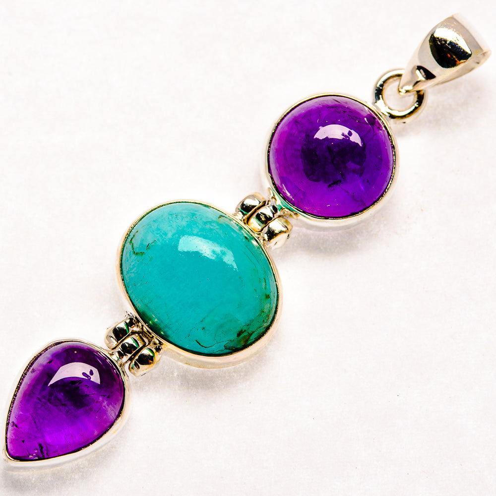 Sterling silver pendant with three settings: two purple amethyst and one blue-green larimar oval.