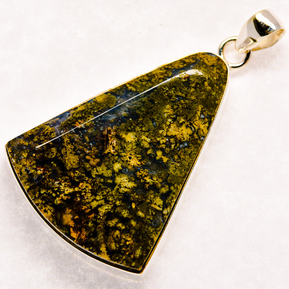 Plume agate pendant with triangular green and dark blue stone, silver bail and bezel frame