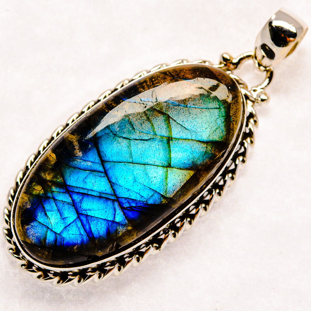 Oval labradorite pendant with silver bezel, vivid blue-green flash stone