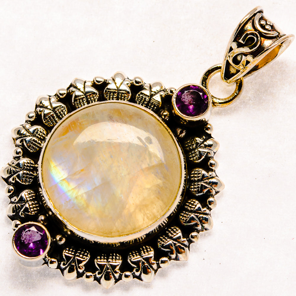Round moonstone pendant with ornate black silver bezel, amethyst accents, and top bail