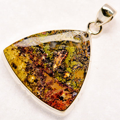Triangular plume agate pendant with silver loop bail, gold, green, and dark speckles