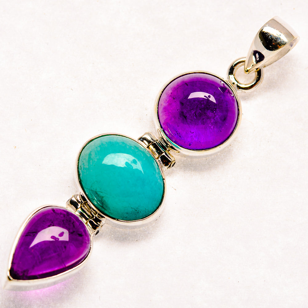 Three-stone sterling silver pendant with purple amethyst, teal larimar, and teardrop settings