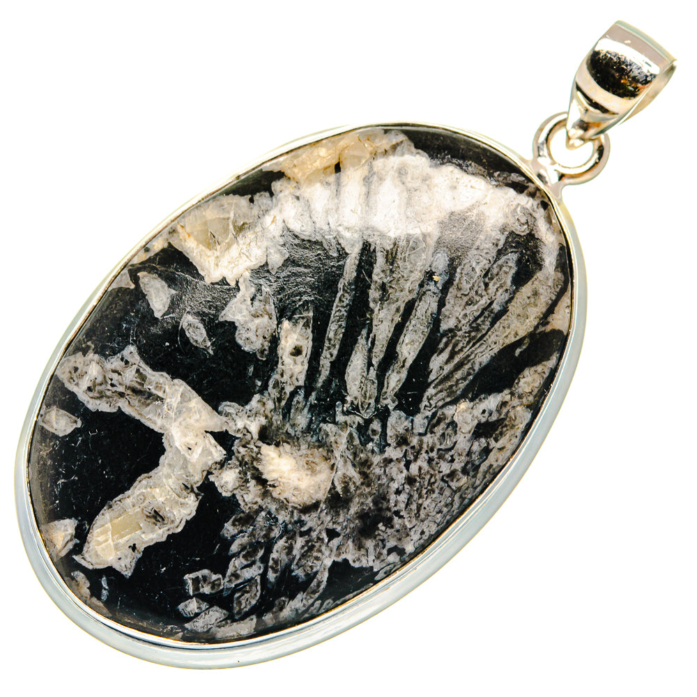 Oval black stone pendant with sterling silver rim and loop bail, detailed natural crystal pattern