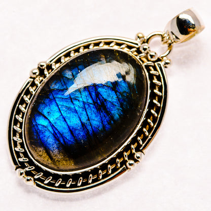 Oval labradorite pendant with blue flash, set in 925 sterling silver openwork bezel