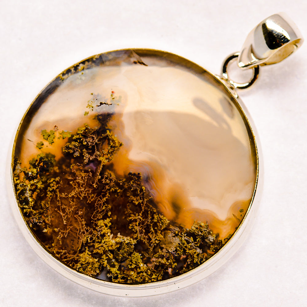 Sterling silver plume agate pendant with round white stone and dark gold mossy inclusions
