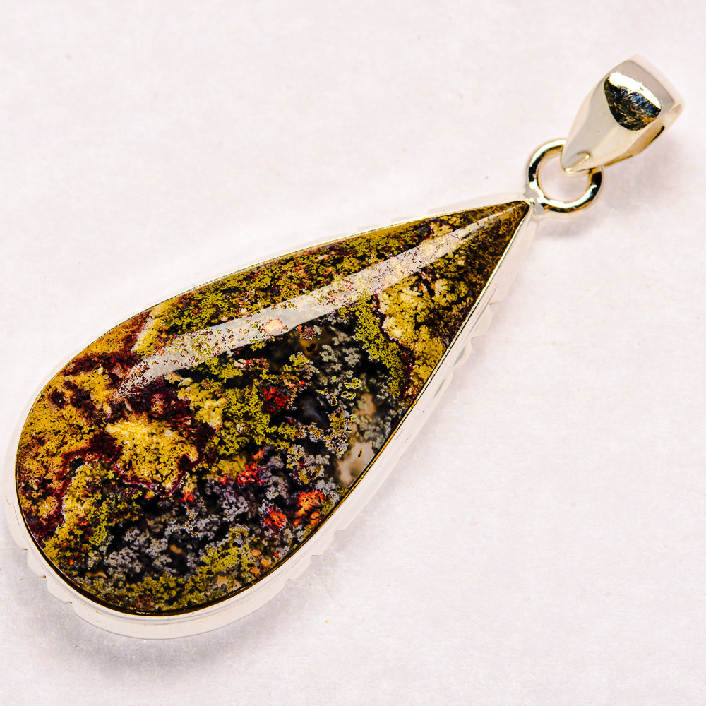 Teardrop plume agate pendant in silver-tone bezel with loop bail