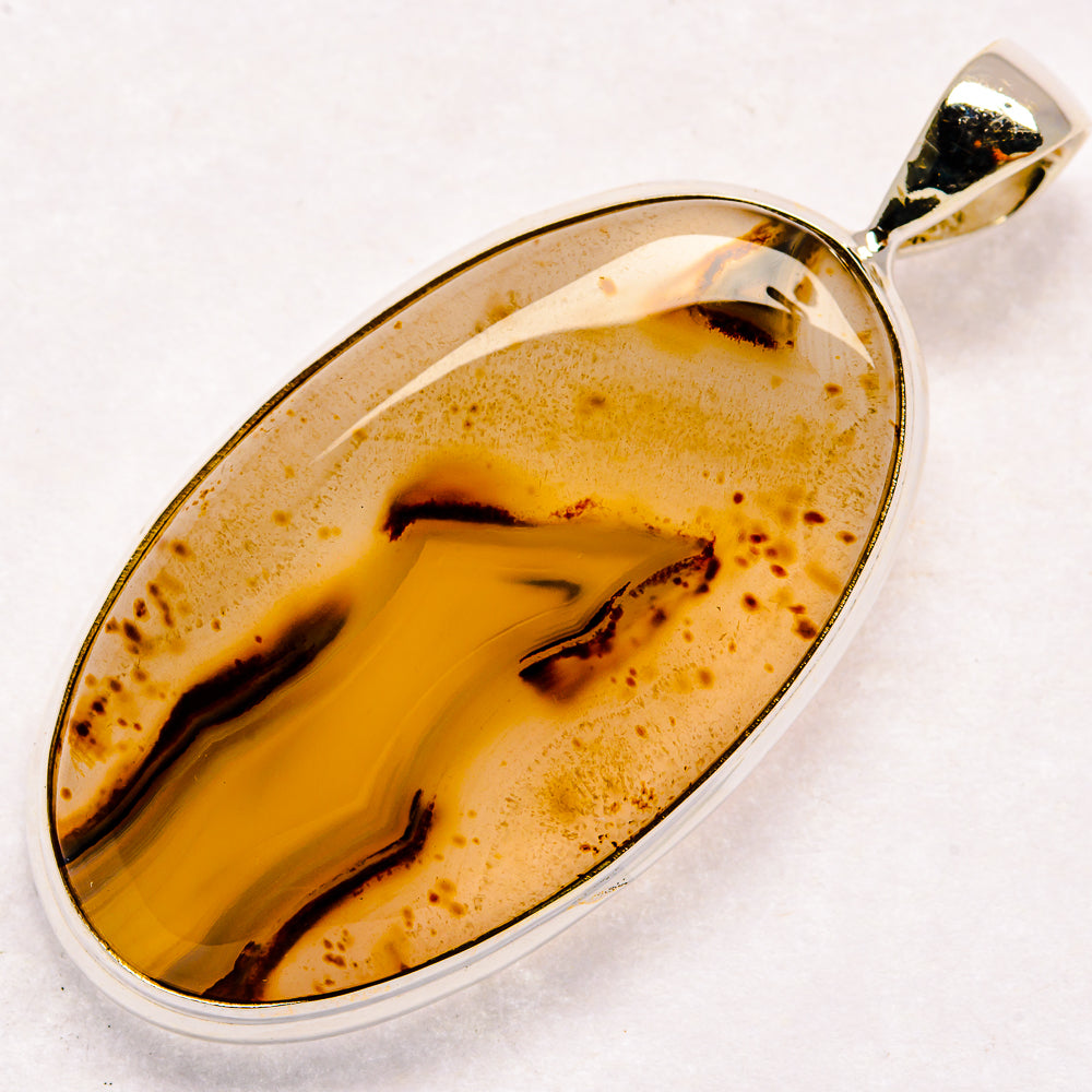 Montana agate pendant with oval cabochon, 925 sterling silver frame and bail, golden amber patterns