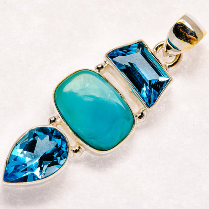 Sterling silver pendant with oval larimar and faceted blue topaz stones, silver bail at top