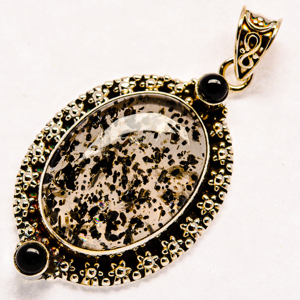 Oval dendritic opal pendant with black onyx stones and ornate sterling silver frame, bail top