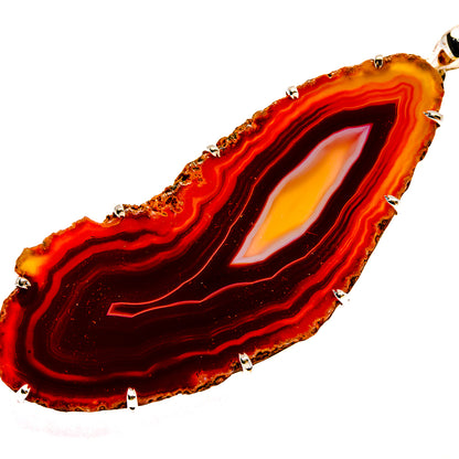 Dark red geode slice pendant with sterling silver bezel and prong-set edge