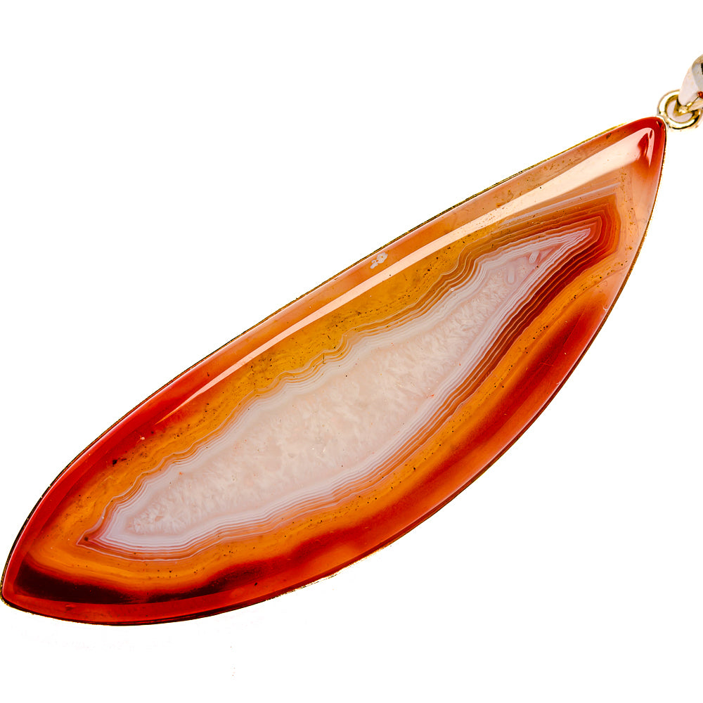 Red geode slice pendant with layered orange stripes and teardrop outline, silver bail