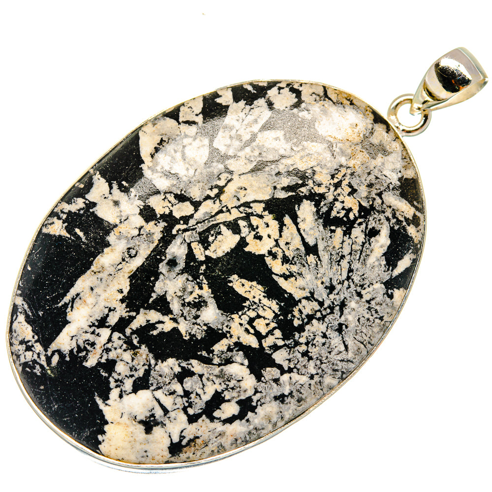 Black-and-white speckled stone teardrop pendant in sterling silver bezel