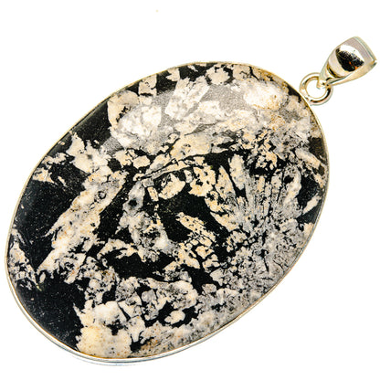 Black-and-white speckled stone teardrop pendant in sterling silver bezel