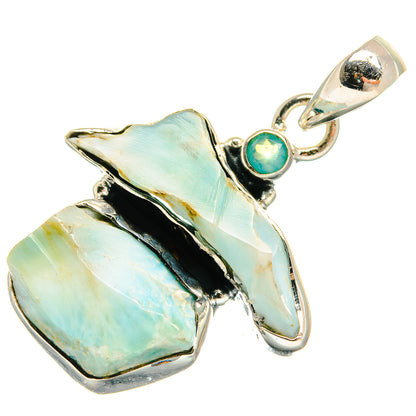 Sterling silver pendant with rough aqua chalcedony cluster and small teal round gemstone on top.