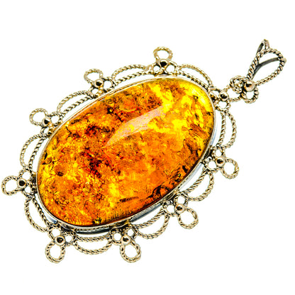 Oval amber pendant with sterling-silver bezel, twisted chain frame, and loop bail