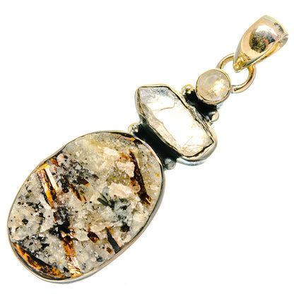 Silver-tone pendant with bezel-set speckled oval gemstone and smaller rough stones.