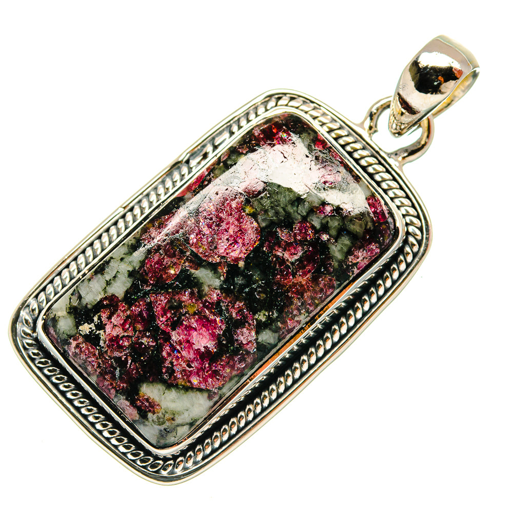 Rectangular sterling silver eudialyte pendant with ornate border and dark green pink stone