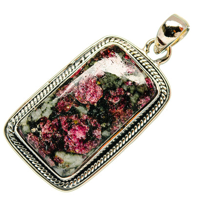 Rectangular sterling silver eudialyte pendant with ornate border and dark green pink stone