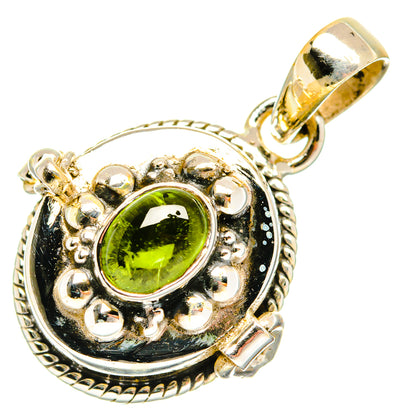 Sterling silver pendant with green oval gemstone in ornate halo bezel.