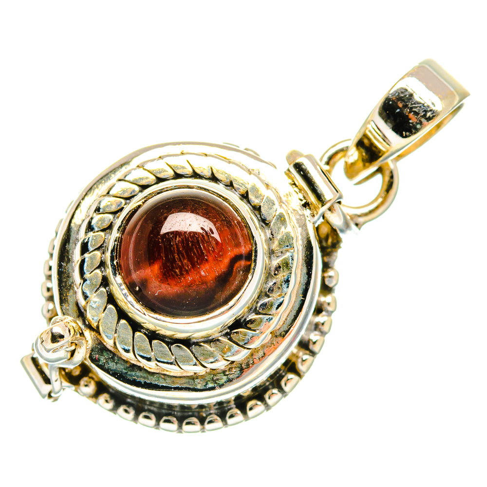 Round tiger eye pendant with red-brown cabochon, ornate silver bezel and bail