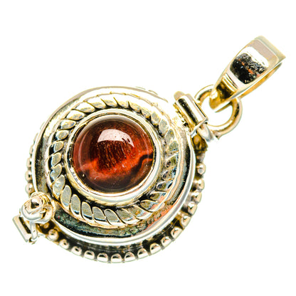 Round tiger eye pendant with red-brown cabochon, ornate silver bezel and bail