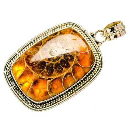 Ammonite fossil pendant in oval silver bezel with warm amber fossil swirl pattern
