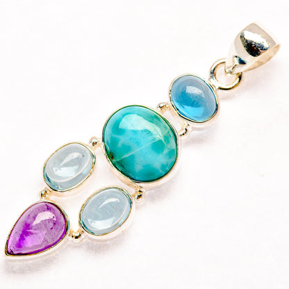 Multi-stone sterling silver pendant with turquoise oval, blue round, purple teardrop, and light stones