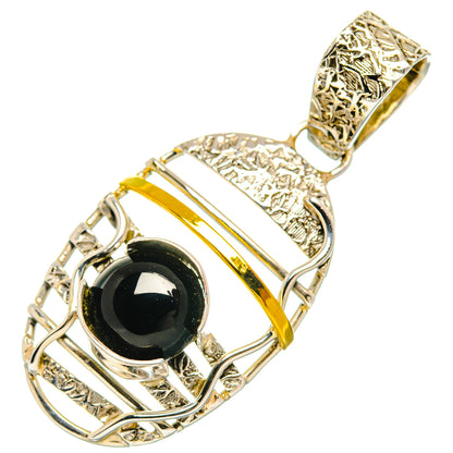 Black onyx oval pendant with ornate silver setting and openwork bail, gold accents