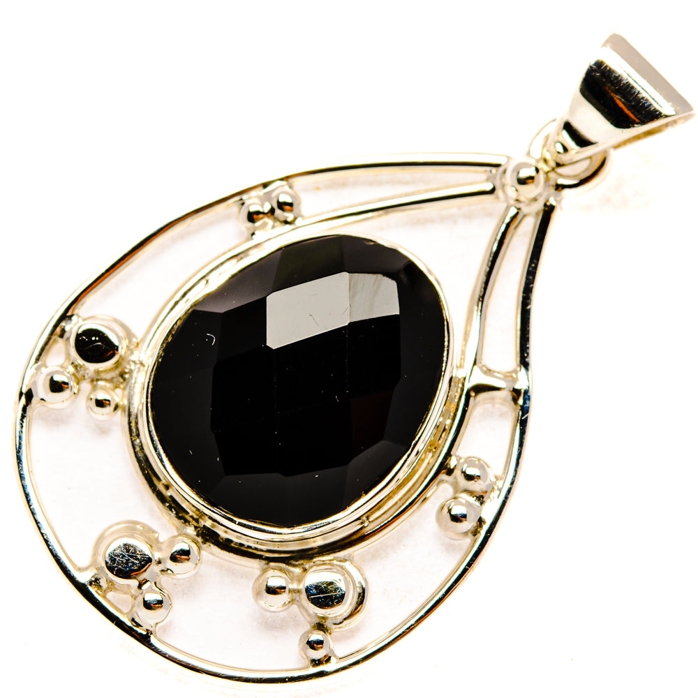 Black onyx teardrop pendant with oval bezel, small stone accents, and silver bail