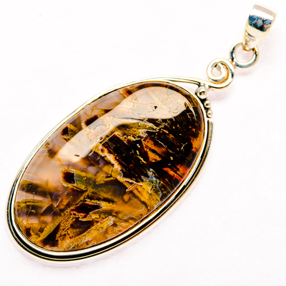 Oval amber-black agate pendant in silver bezel with hanging loop bail